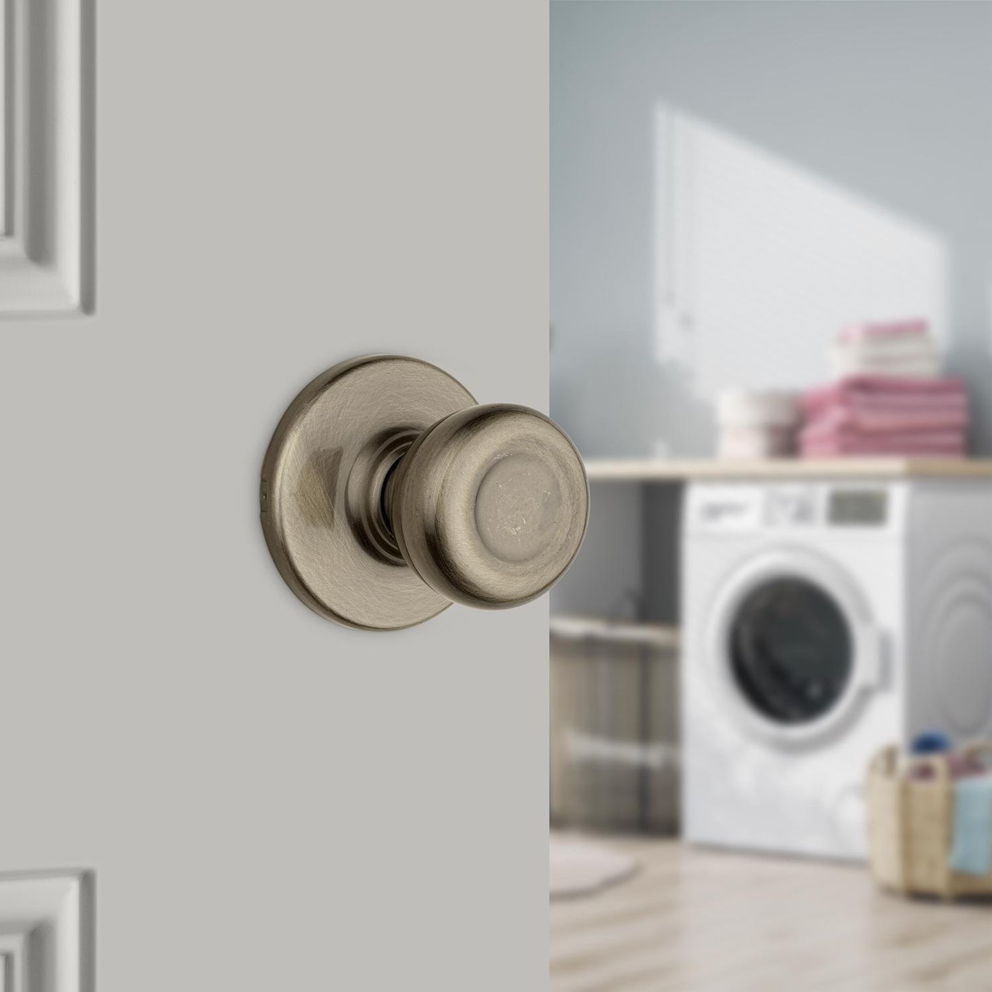 Kwikset Tylo Passage Door Knob, Antique Brass, ANSI/BHMA Grade 3, Fits 1-3/8–1-3/4 in Doors