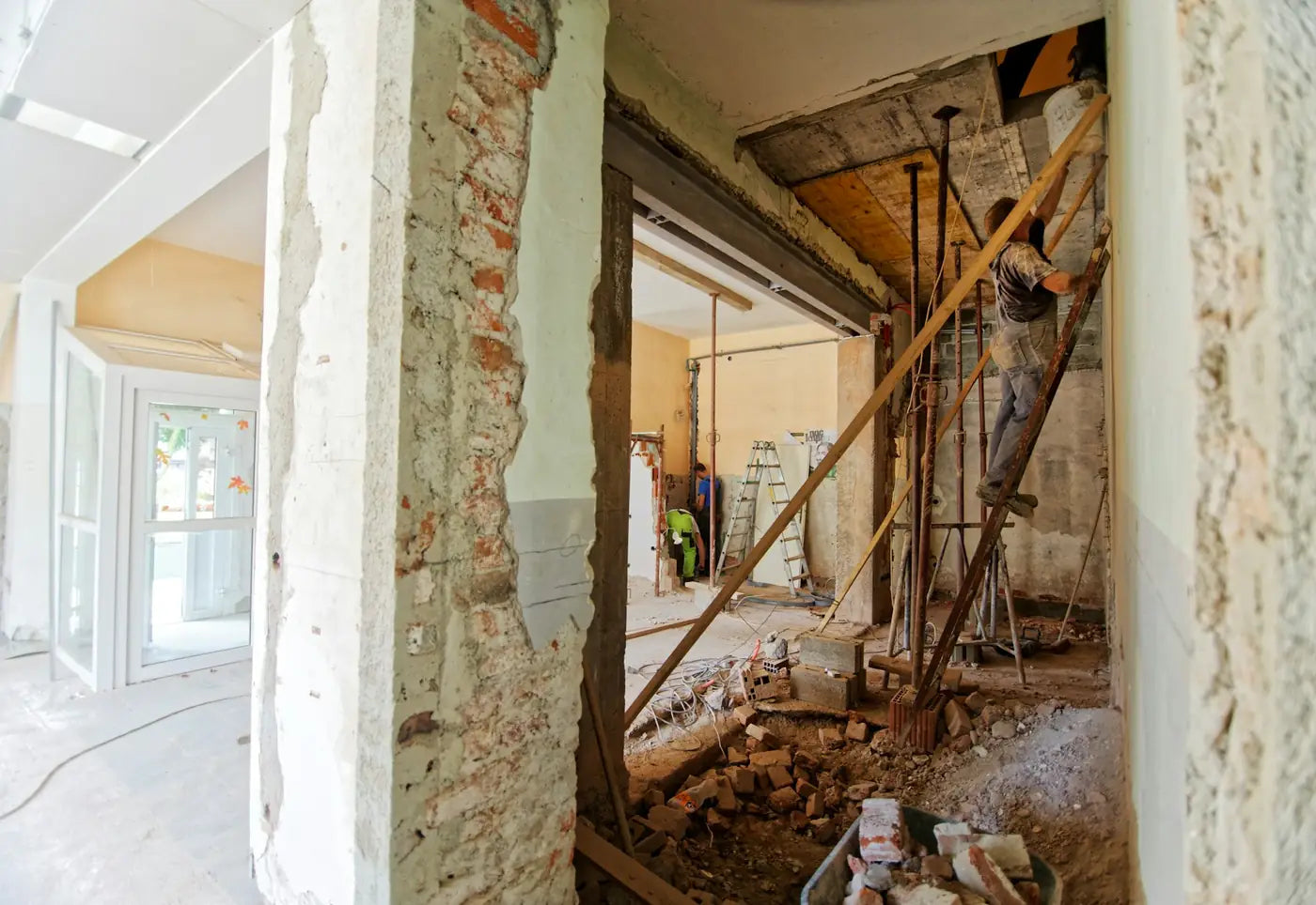 A crew working on ladders inside a home mid-renovation